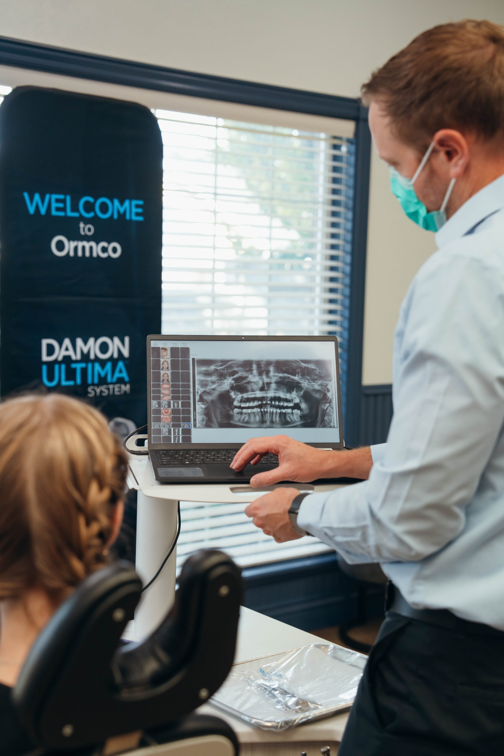 Dr. Prince reviewing dental X-rays with a patient at Prince Orthodontics in American Fork for personalized treatment planning.