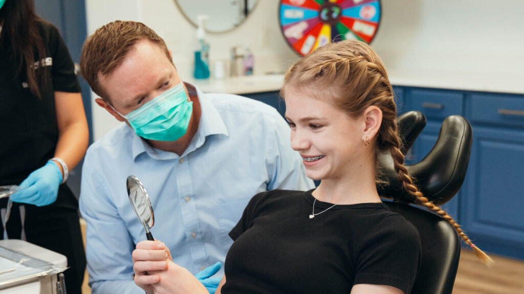 Teenager admiring good braces treatment at Prince Orthodontics, near American Fork, Utah