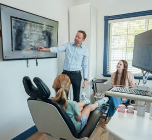 Dr. Prince consulting with a teenage patient about orthodontic treatment options.
