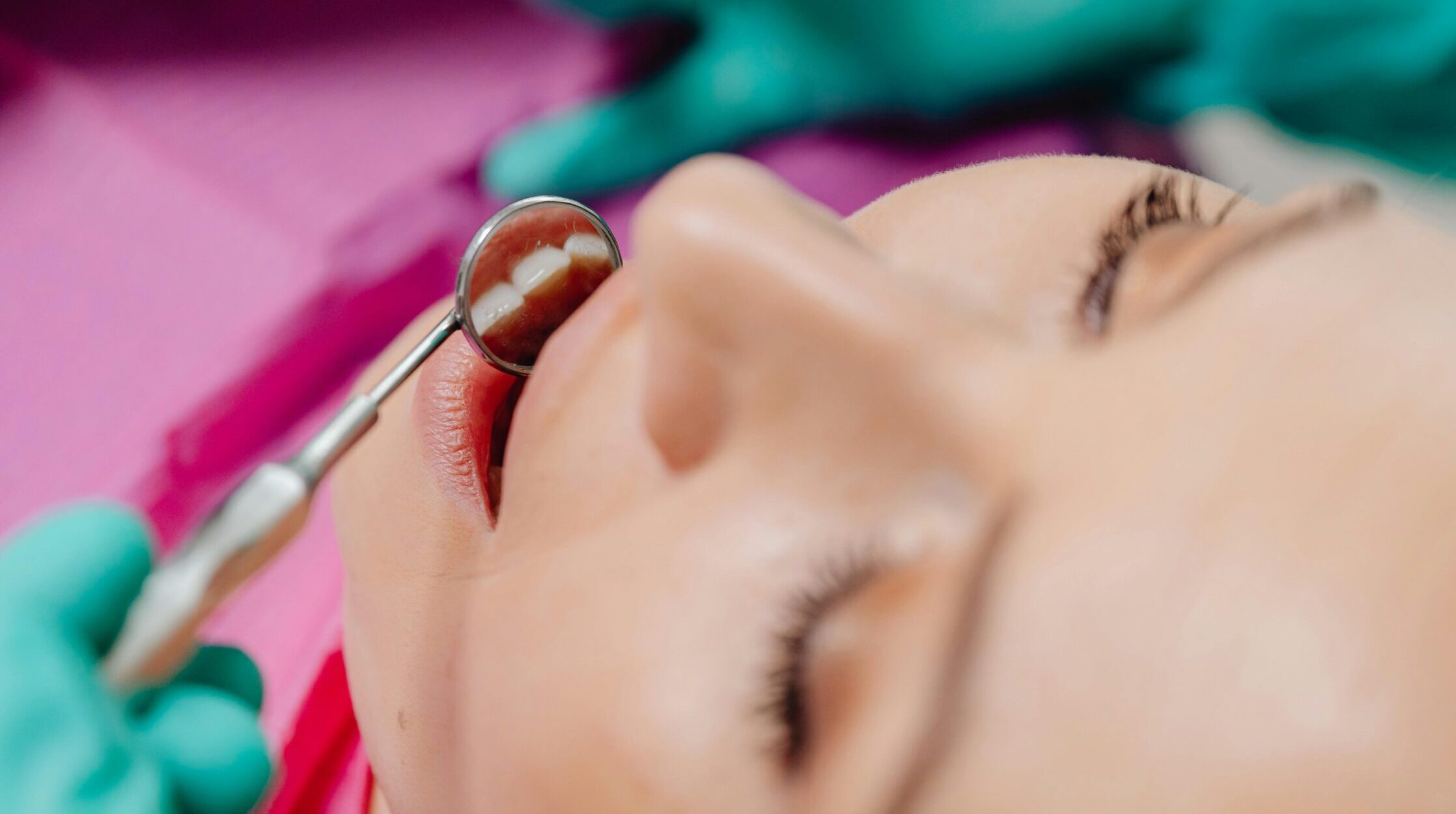 Woman receiving an orthodontic exam to check if she needs braces.