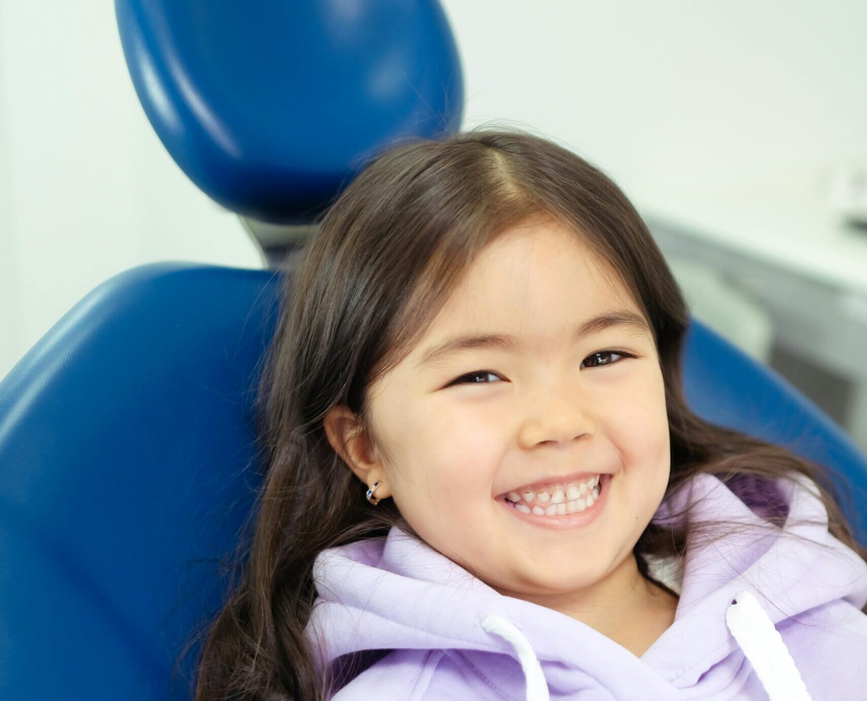 Young girl sitting in orthodontist chair during her first orthodontic consultation in American Fork Utah