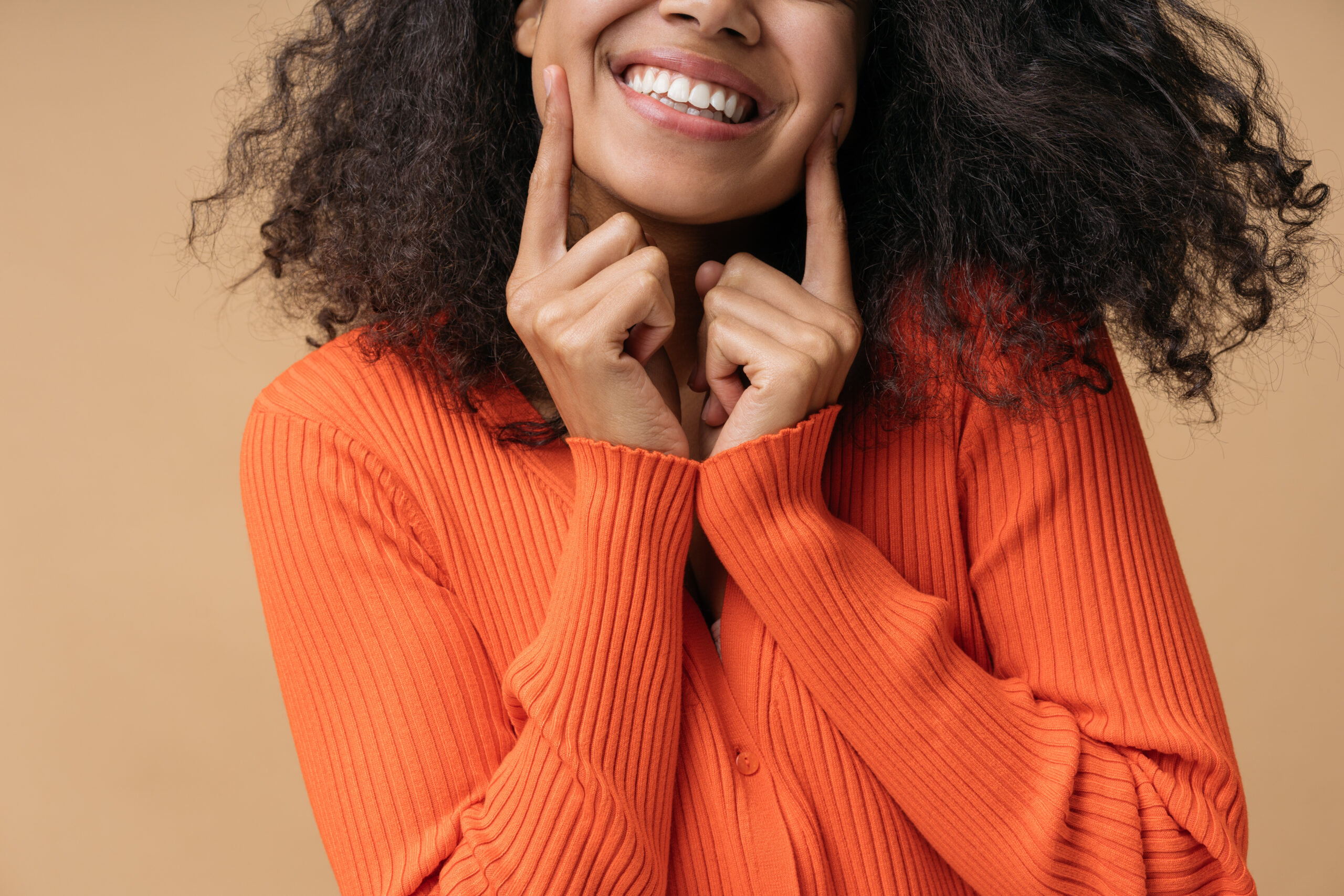 Smiling person showing healthy teeth for a blog about whether braces can fix an overbite, underbite, or crossbite.