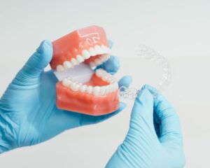 Dr Prince at Prince Orthodontics in American Fork, UT holding a clear retainer.