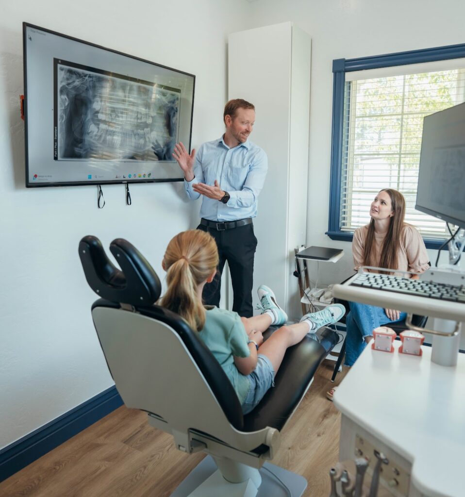 Dr. Steven Prince performing consultation with child and mother at Prince Orthodontics in American Fork, UT